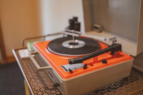 An orange record player sits ready for a record.