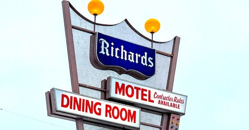 A retro sign with yellow globe lights and red and blue colors reads "Richards / Motel / Dining Room."