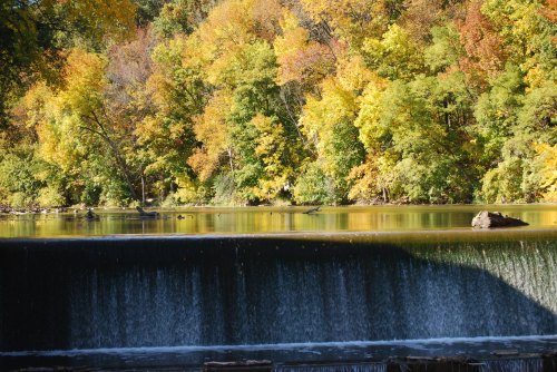 Fall foliage sits above a man-made waterfall in Sheboygan, Wisconsin.