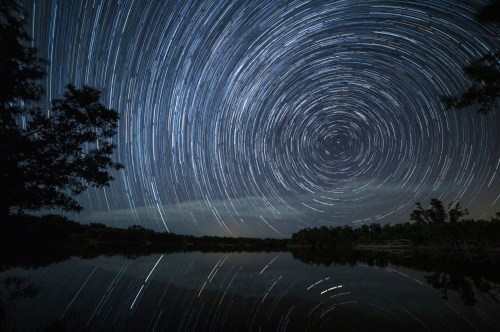 A timelapse of a starry night creates a circular pattern as the passage of time.