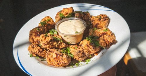 A plate of smoked Hungarian sausage and fried walleye bites served at Larder, a nationally-recognized restaurant in Cleveland, Ohio.