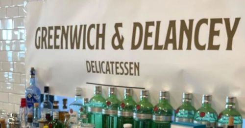 A bar wall that says "Greenwich & Delancey"
