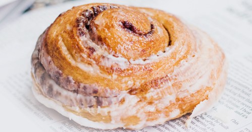 A large, glazed cinnamon roll from Morning Rose Coffee Shop in WaKeeney, Kansas.