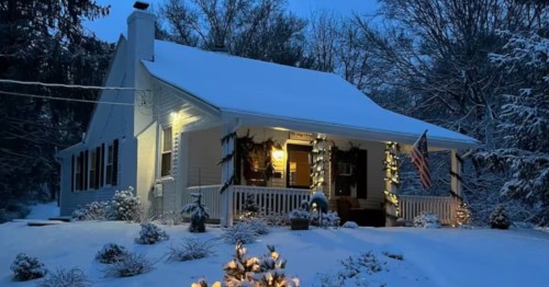 exterior of a cozy home on a hill covered in snow in the evening in rhode island