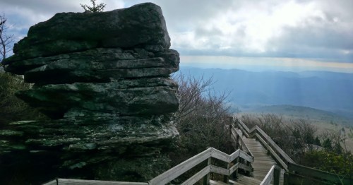 A boardwalk staircase on a hiking trail in North Carolina overlooking the Blue Ridge Mountains.