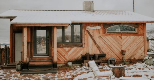 exterior if a modern cabin covered in snow in northern arizona