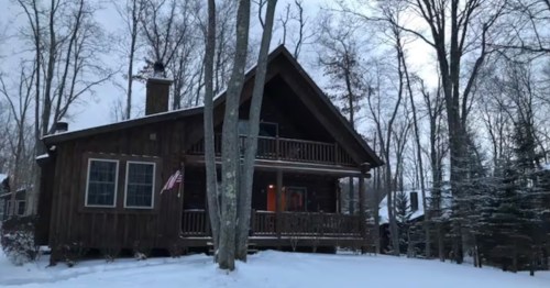 exterior if a large rustic cabin surrounded by a snowy landscape in maryland