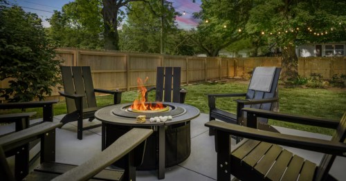 Kansas City vacation rental hot tub on deck with robes, set against a sunset.