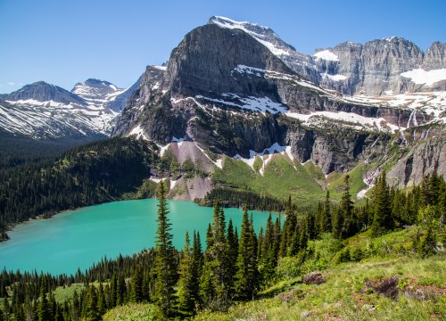 Mountains and clear alpine lakes in Glacier National Park, Montana, showcasing rugged peaks and pristine natural scenery.