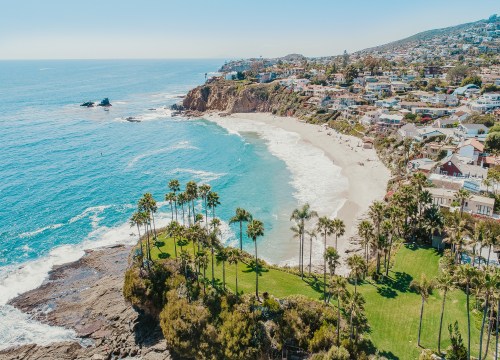 Aerial view of Laguna Beach, California, showing coastline, ocean, and beachfront homes