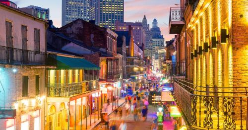 aerial view of the French Quarter of New Orleans at night, lit up around Mardi Gras