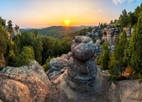Rock formations silhouetted against a warm summer sunset at Garden of the Gods in Southern Illinois.