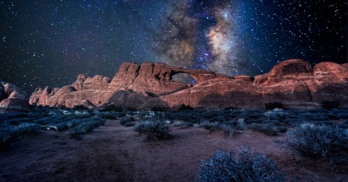 Arches National Park under a starry night during a Dark Sky stargazing event in Utah.