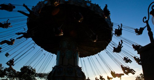 silhouette of people on a swing carousel at canobie lake park in salem new hampshire