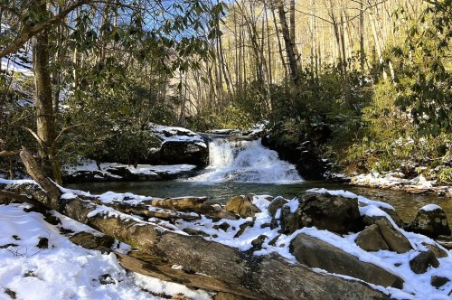 Scenes of Hemlock Falls in Georgia covered in snow and surrounded with forest on a pretty winter day