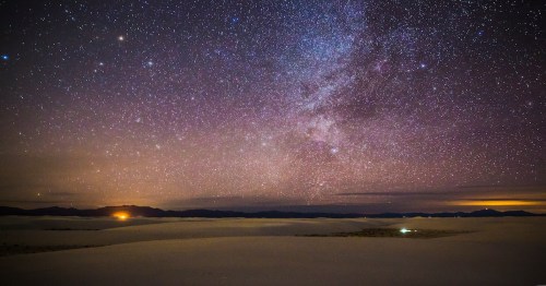 dark purple and blue skies filled with twinkling stars above a national park in new mexico