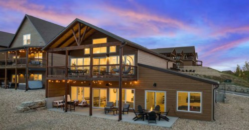Patio view of extra large vacation home near Branson, Missouri with pool and fire pit.