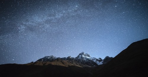 Night landscape and starry sky with the Milky Way over the mountains in Georgia