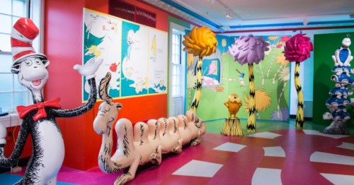 Life-sized Dr. Seuss characters and Truffula trees in a colorful, whimsical museum exhibit.