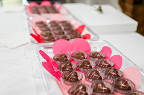 Clear trays line the table with little candy hearts in each cup.