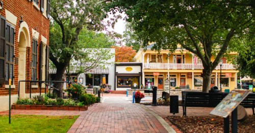 A scenic brick walkway leads through the historic, tree-lined downtown square of Dahlonega, Georgia.