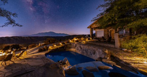 A stunning pool reflects a night sky bright with stars.