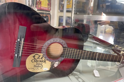 A signed red acoustic guitar by Ozzy Osbourn.