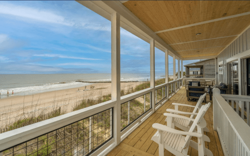 Waterfront vacation rental with a deck and beach views