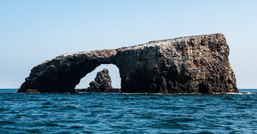 an arch rock natural bridge in the ocean at channel islands national park