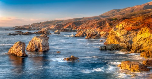 Crashing waves of water on the granite coastline of Garrapata State Park in California's Central Coast.