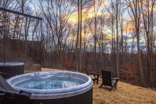 A reflective house sits behind a cozy jacuzzi, surrounded by leafless trees under a setting sun in New Plymouth, Ohio.