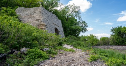 trail that leads to a structure surrounded by trees and bushes in missouri
