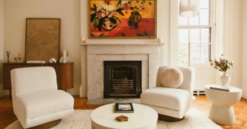 Beautiful Airbnb in Providence: Bright living space with modern furniture, artwork, and a large window.