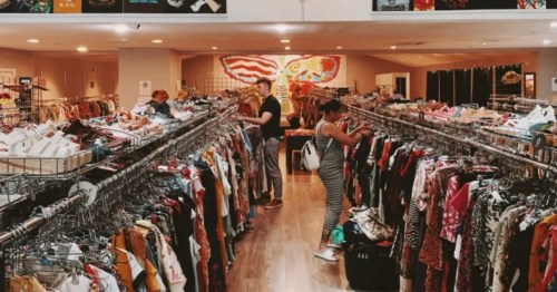 Woodstock Vibes thrift store, New Jersey: Customers shopping among racks of clothing and wall displays.