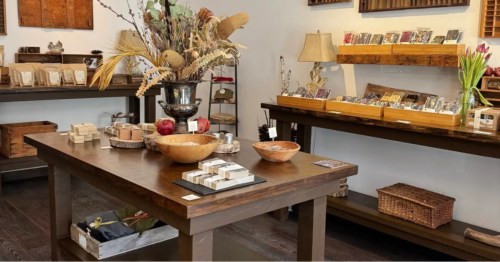 Interior of Tavernier Chocolates, a chocolate shop in Vermont, with a table and a shelf with chocolates.