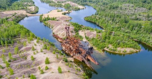 Aerial view of abandoned gold dredge in water