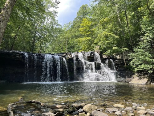 Waterfall in Brush Creek Preserve in West Virginia, with green trees surrounding