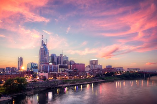 The pink hues of a sunset over the skyline of Nashville.