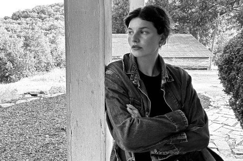 Woman looking pensively in a farm setting