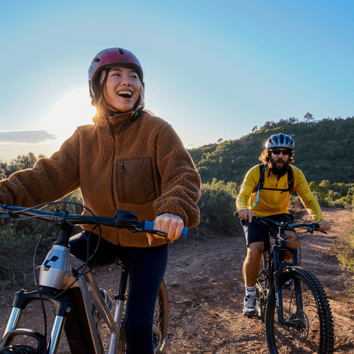 Two bikers on gravel path in sunny location