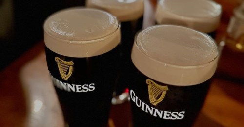 pints of Guinness on a table at dooliner irish pub in newton ma