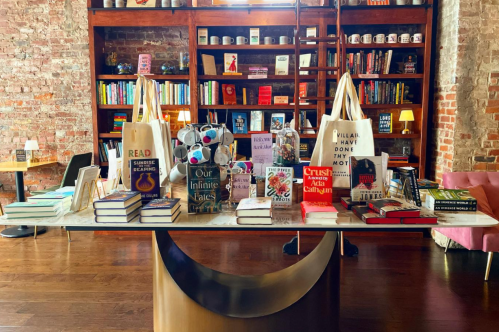 Large table filled with love themed books at Nook and Nowhere in Louisville, Kentucky