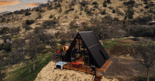 an a-frame cabin at the bottom of a hill in california