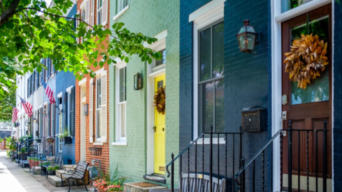 Colorful row homes in Old Town Alexandria, VA and a sidewalk.
