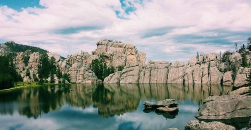 A reflective lake and surrounding rock formations.