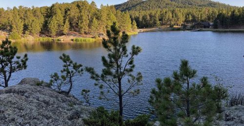 A view of a lake with the Legion Lake Lodge behind it.