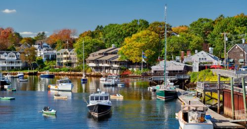 The marina and shoreline in Portland, Maine, with boats and all types of trees