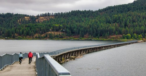 Two cyclists cross over a bridge along the Trail of the Coeur d'Alenes in northern Idaho.