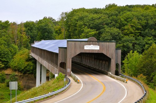 View of Smolen-Gulf Covered Bridge, the longest covered bridge in America, surrounded by a heavily wooded area