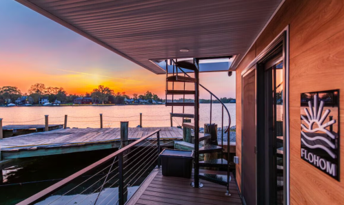 The sun sets over the deck of a floating tiny home rental in Maryland.